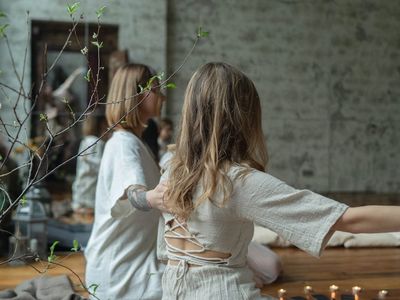 A small plant and candles in a serene practice corner.