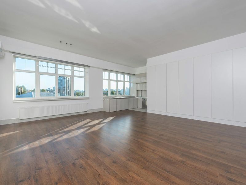 Spacious bright room with yoga mats and large windows.